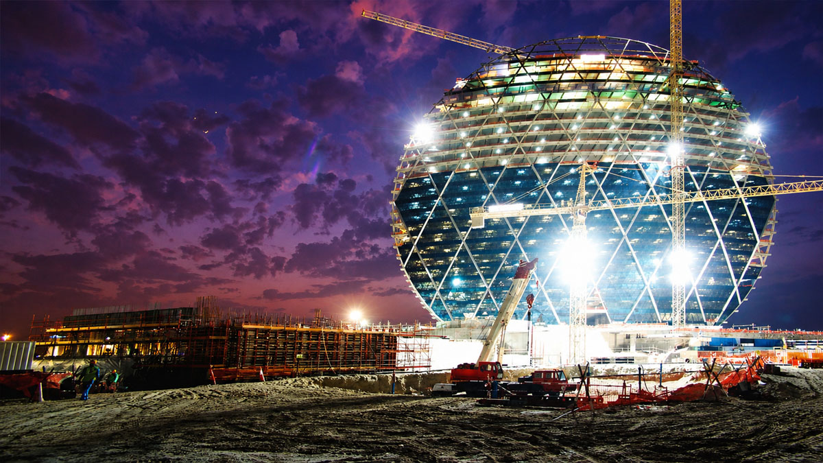 Aldar tower construction at dusk
